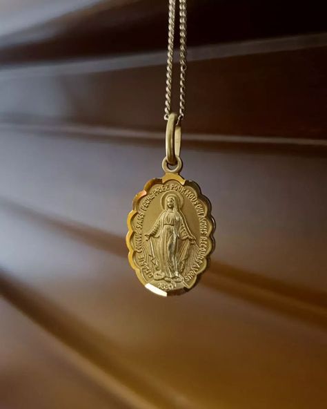 The Miraculous Medal - a Catholic medallion gold necklace | This medal started with Mary appeared to Saint Catherine Labouré during her second apparition on November 27th, 1830.

"The medal would be a sign of love, a pledge of protection and source of grace for those who would trust in it. All the people who will wear it will receive great graces especially if they wear it on their neck; graces will be generous for those who will wear it with trust.”, the Virgin Mary to St. Catherine Labouré. Mary Necklace Gold, Miraculous Medal Necklace, Sign Of Love, Saint Catherine, Be Generous, Catholic Necklace, Catholic Medals, Grandma Birthday, Catholic Jewelry