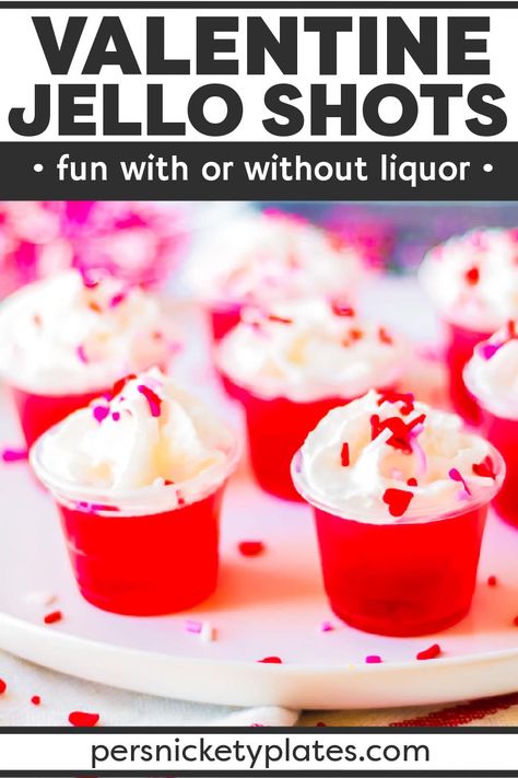 Celebrate Valentine's Day with your loved ones this year with these delicious Valentine's day jello shots! Made with layers of pink and red jello infused with clear vodka (or left non-alcoholic), they couldn't be easier to make. Topped with whipped cream and sprinkles, these irresistible jello shots are always a hit! | www.persnicketyplates.com Valentine Jello, Jello Shots Vodka, Persnickety Plates, Cranberry Jello, Jello Flavors, Kid Friendly Drinks, Jello Shot, Family Desserts, Jello Shot Recipes