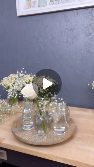 FLOWERS | FLORIST | WEDDINGS | DELIVERY | NYC | BROOKLYN on Instagram: "Popular bud vases 2024 ! Brilliant idea to use lazy  Susan for buds it was much faster.  ✨ Beautiful white roses and delicate baby’s breath in charming glass bottles, perfect for a stunning wedding centerpiece. Elevate your special day with our exquisite floral arrangements! 🌸  Discover the magic of our floral designs and make your wedding unforgettable with the finest flowers in New York. Contact us to bring your floral dreams to life! 💍💐  #NYWeddingFlowers #NewYorkFlorist #WeddingFlowersNYC #NYCWedding #WeddingInNYC #NYCFlorist #NYCWeddings #NYCBrides #FlowerArrangements #WeddingBouquet #WeddingDecorations #WeddingFloralDesign #NYCEvents #LuxuryWeddings #BridalFlowers #NYCWeddingPlanner #WeddingInspiration #LoveIn Bud Vases Wedding Centerpiece, You're Somebody Else, Flora Cash, Rose Centerpieces Wedding, Bud Vases Arrangements, Bud Vases Wedding, Nyc Florist, Mini Carnations, Bottle Centerpieces