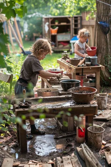 Children playing with mud and water at outdoor activity tables in a garden setting. Kids Garden Play Area, Mud Kitchen Ideas, Outdoor Play Kitchen, Mud Kitchen For Kids, Kitchen For Kids, Outdoor Kids Play Area, Diy Ideas For Kids, Play Area Ideas, Small Backyard Design Layout