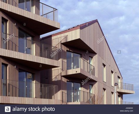 Download this stock image: Balconies, timber facade and gabled roof. Bruyn's Court, South Ockendon, United Kingdom. Architect: Bell Phillips Architects, 2016. - JGGKKK from Alamy's library of millions of high resolution stock photos, illustrations and vectors. Timber Facade, Gabled Roof, Pitched Roof, Balcony, Architects, Roof, United Kingdom, Stairs, Stock Images