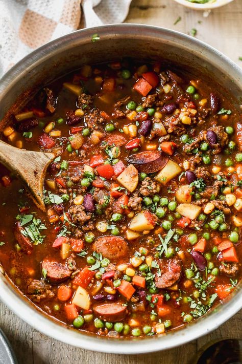 With ground beef, kielbasa, beans, potatoes and veggies, this hearty cowboy stew recipe has chili vibes but packs in even more satisfaction! Camping Stew Recipe, Kielbasa Beans, Cowboy Stew Recipe Ground Beef, Camp Stew Recipe, Cowboy Soup Recipe, Beef Kielbasa, Cowboy Stew Recipe, Texas Cowboy Stew, Meat Soups