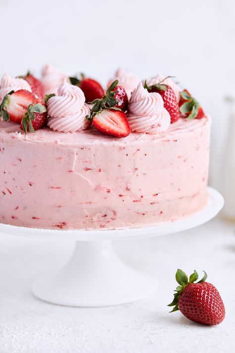 Spongey, buttery vanilla cake is sandwiched with fresh strawberries and coated in a strawberry frosting. Recipe by Tutti Dolci. #californiastrawberries #springcake #dessertrecipes #cakerecipe #strawberrycake #layercake #vanillacake #bakingathome #vanillastrawberrycake #springrecipes #strawberrydessert Tiered Strawberry Cake, Pretty Strawberry Cake Birthday, Vanilla Cake Strawberry Frosting, Strawberries Birthday Cake, Strawberry Heart Cake Aesthetic, Strawberry Cake With Frosting, Cake That Looks Like A Strawberry, Strawberry Frosted Cake, Beautiful Strawberry Cake