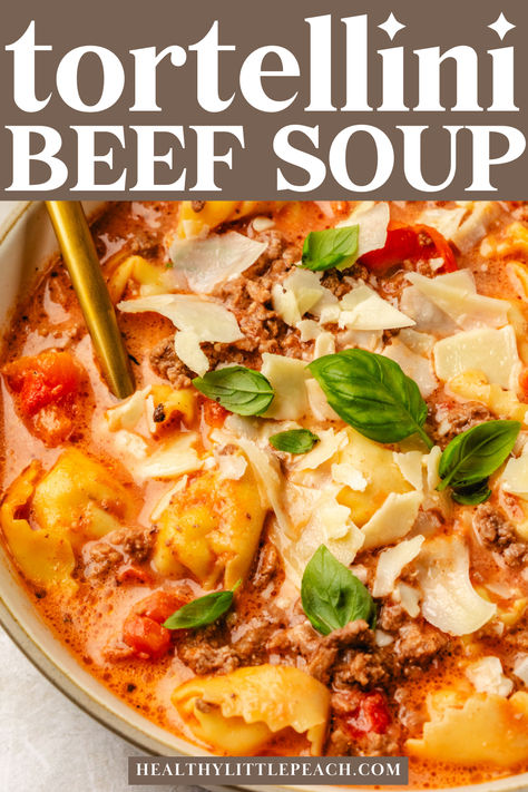 A pinterest pin for creamy beef tortellini soup. A photo of a bowl with soup garnished with basil Cheeseburger Tortellini Soup, Creamy Meatball Tortellini Soup, Creamy Beef Tortellini Soup, Tortellini Bean Soup, Tortellini Soup With Ground Beef, Healthy Tortellini Soup Recipes, Beef Tortellini Soup Recipes, Soup With Mini Meatballs, Tortini Soup