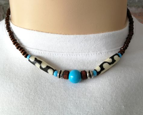 An awesome wood bead necklace! ~ D E T A I L S ~ ~  4mm brown wood beads ~  10mm turq howlite gemstone .   bead ~  African batik bone beads  ~  turq seed beads ~  lobster clasp  ~  handmade ~  LENGTH ~   (choose from drop down menu) ~ S H I P P I N G ~ Please see the Announcement on our shop Bone Bead Necklace, African Beads Necklace, Mens Beaded Necklaces, Beaded Memory Wire Bracelets, Wire Bracelets, Surfer Style, African Necklace, Bone Pendant, Bead Choker