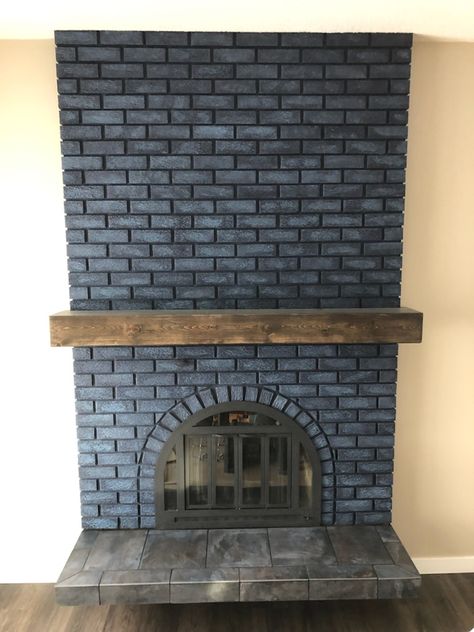 Painted fireplace first with SW primer, then 2 coats of Naval. Last was a wash (1 part white, 1 part blue, 4 parts water) painted and dabbed one to three bricks at a time. Mantle was built out of knotty pine. Distressed and stained with Varathane Kona. Installed using a french cleat attached to old mantle. Brass doors were scuff sanded and spray painted with Rust-Oleum high heat enamel. Lastly, the tiles were removed from the hearth and replaced with Gulfstream Islands tile. Blue Brick Fireplace Paint Colors, Charcoal Blue Fireplace, Dark Blue Painted Brick Fireplace, Dark Blue Brick Fireplace, Black Fireplace Blue Wall, Painted Brick Fireplace Color, Navy Blue Painted Brick Fireplace, Navy Blue Brick Fireplace, Navy Painted Fireplace