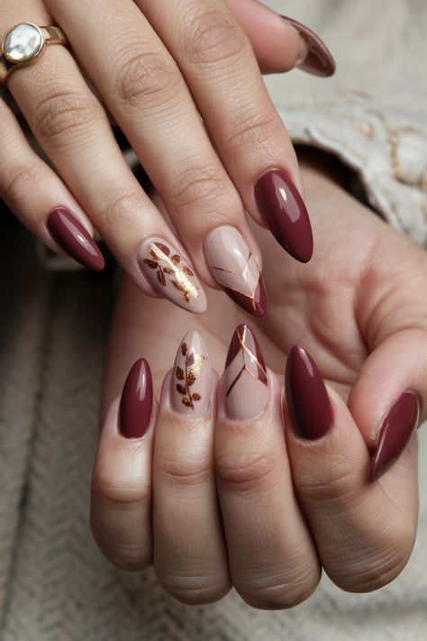 Embrace the beauty of autumn with these chic acrylic fall nail ideas that perfectly capture the season's essence. Picture deep burgundy and burnt orange swirls adorned with delicate gold leaf accents, showcasing a warm, inviting vibe. These nails not only add a touch of sophistication but also express your appreciation for fall窶冱 rich colors. Get inspired and bring the essence of autumn to your fingertips! November Birthday Nails Ideas, Burgundy And Gold Almond Nails, Fall Nails Pink And Brown, Maroon Autumn Nails, Wine And Gold Nails Designs, Burgundy Thanksgiving Nails, Cranberry Nails Fall Designs, Burgundy With Gold Nails, Fall Nails Burgundy Gold