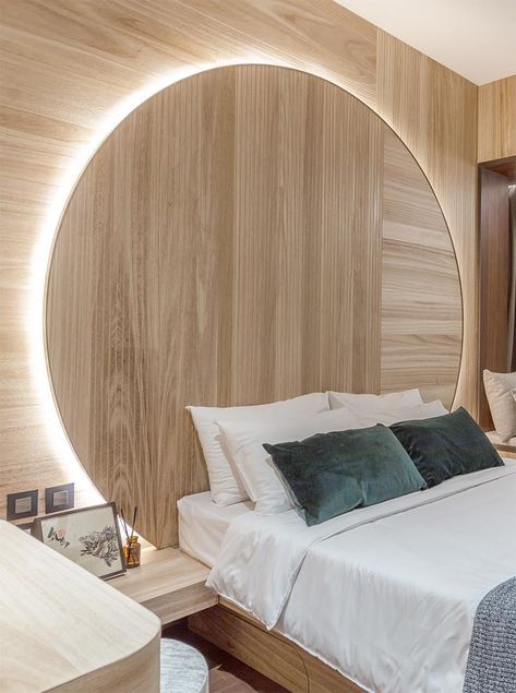 Bedroom Idea - Using natural materials to create a sense of warmth and calm, the design of this circular headboard observes the Chinese concept of “Earth’s a square; heaven a circle”. It also has hidden lighting that creates a soft glow and outlines the design element. #BedroomIdeas #HeadboardIdeas #CircleHeadboard #CircularHeadboard #Lighting Circular Headboard, Bedroom Paint Colors Master, Hidden Lighting, Feature Wall Bedroom, Modern Apartment Design, Accent Wall Bedroom, Bedroom Headboard, Modern Bedroom Design, Bedroom Paint