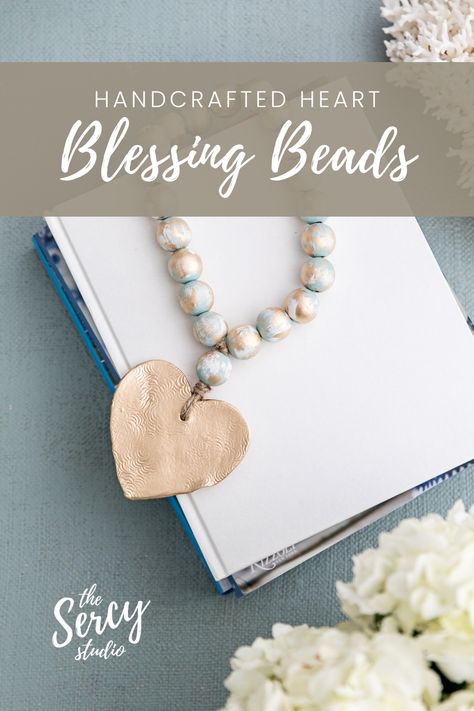 The Nancy blessing beads with a gold heart pendant is laying across a stack of books. Blessing Beads Meaning, Beads Meaning, Blessing Beads, A Stack Of Books, Keepsake Gifts, Gold Cross Pendant, Stack Of Books, Gold Accent, Gold Cross