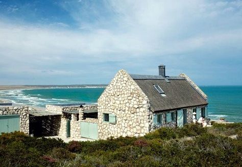 Stone Beach Cottage | Set on a private nature reserve overlooking several miles of undisturbed beach in Paternoster, on the West Coast of South Africa, the cottage is Built from Local Stone and designed to blend in. What does pop out are the pale Aqua of the shutters and gates, a color inspired by the sea. You find subtle touches of it throughout the house. Christmas Rooms, Nautical Cottage, England Country, Beach Decorations, Stone Beach, Cottage Shabby Chic, House Cottage, Sea House, Cottage Exterior