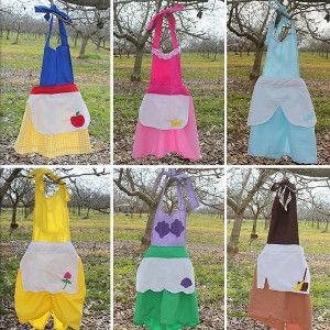 6-for-1 Princess Apron Tutorial - Make your little girl's fairy tale wishes come true by getting out your sewing materials. This 6-for-1 Princess Apron Tutorial is just what you need to dress up your daughter to look like all her favorite Disney princesses. Princess Apron Pattern, Disney Princess Aprons, Princess Aprons, Disney House, Cake Land, Apron Tutorial, Princess Diy, Aunt Life, Diy Halloween Costume