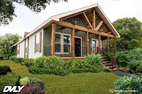 Pensacola, Florida–based Sanders Housing partners with Deer Valley Homebuilders and Mossy Oak to construct their nature-inspired series of four modular homes. This three-bedroom, two-bathroom home has exposed wood beams on the interior and exterior and rustic wood finishes throughout. Deer Valley Homes, Vinyl Window Trim, Interior Door Knobs, Prefab Home, Unique Floor Plans, Fibreglass Roof, Roof Trusses, Deer Valley, Ranch Style Home