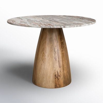 The compact design of this round dining table makes it easy to host cozy, casual dinners or coffee chats with a few close friends. A solid wood pedestal base comes in a medium brown stain that highlights the variations in the wood grain for a hint of warmth. The table top is made from marble in a contrasting tone, with intentional smoothness to complete the overall design. Able to seat four people comfortably, it's a welcome addition to smaller dining areas and kitchens. Table Top Color: Pink, S Marble And Wood Dining Table, Marble Pedestal Dining Table, Wood Base Dining Table, Marble Pedestal, Round Marble Dining Table, Small Dining Area, Dining Table Bases, Trestle Dining Tables, Wood Pedestal