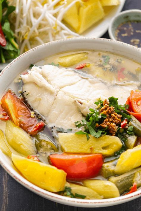 Canh Chua is an iconic Vietnamese Sour Soup, loved for its broth that's sweetened by pineapple and garnished with fresh herbs! #vietnamesesoursoup #vietnamesesoup #canhchua Sour Fish Soup, Sweet And Sour Soup, Canh Chua, Vietnamese Soup, Khmer Food, Viet Food, Fish Soup, Sour Soup, Vietnamese Cuisine