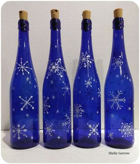 Blue Wine Bottles Diy, Painted Blue Wine Bottles, Blue Wine Bottle Crafts, Christmas Wine Bottle Crafts Diy, Blue Christmas Decor Ideas, Painted Snowflakes, Bottle Crafts Christmas, Wine Bottle Crafts Christmas, Holiday Wine Bottles