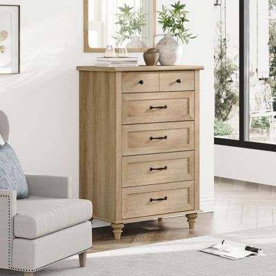 This 5-drawer dresser complements any French country space while offering lots of extra storage space. Its frame is made from engineered wood with a rustic white and brown finish, and it rests on turned legs for a classic silhouette. The five spacious drawers open on metal slides and provide ample room for everything from your clothing and linens to delicates and jewelry. We love how the black-finished metal drawer pulls around out its farmhouse look in your bedroom or guest room. Plus, there's Narrow Wood Dresser, Tall Dressers For Bedroom, Tall Dresser Styling, Tall Wood Dresser, Tall Dresser Decor, Tall Dressers, Dresser Styling, Bedroom Furniture Ideas, Bedroom 2024