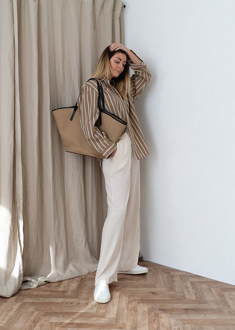 Emma Hill wears brown and white stripe oversized shirt, white wide leg trousers, white trainers, neutral canvas tote bag. Chic causal Spring Summer outfit White And Beige Outfit Summer, Trousers With Shirt Women, Beige And White Striped Shirt Outfit, Oversized Striped Shirt Outfit Women, Brown Striped Button Up Outfit, White And Brown Striped Shirt Outfit, Causal Trousers Outfit, Beige Oversized T Shirt Outfit, Light Brown And White Outfit