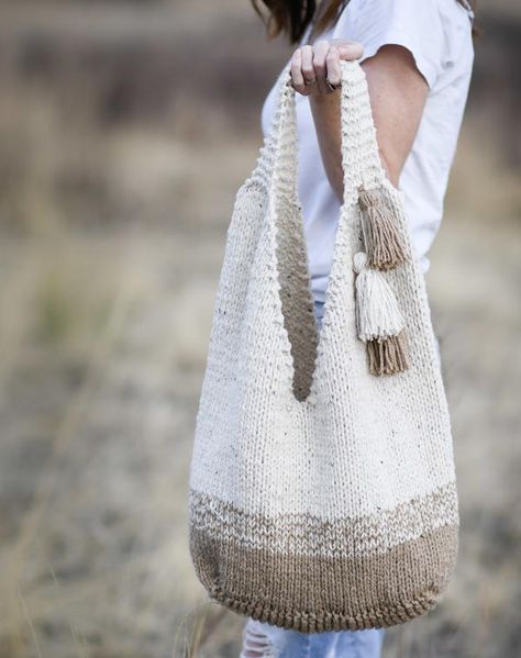 Carry your necessities and more in this gorgeous, oversized knit bag. Featuring a slouchy design and wide straps, it’s both comfortable and practical.  Playful tassels add fun and flair to your new fave knit tote. This bag is made by first knitting a rectangular base.  Next, you will pick up stitches around the base and proceed to knit in the round.  Stitches are then split to work the shaping at the top and then again at the handles.  The entire bag is knit while holding two strands of yarn tog Knitting Tote Bag Pattern, Mama In A Stitch, Tote Crochet, Slouchy Tote, Free Crochet Bag, Knitting Tote Bag, Knitting Tote, Slouchy Bag, Lion Brand Yarn