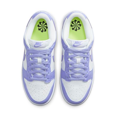 Take a step back in time while freeing the environment from some of its human-caused burden with the Nike Dunk Low Next Nature Lilac Women. Crafted with 20% recycled materials, these eye-catching shoes provide an inspiring take on retro style. The upper is designed using white leather and punctuated with perforated toe box for added breathability. Violet hues appear throughout, tinting the overlays and laces as well as adding a subtly branded touch via a purple Nike label on the tongue. To complete the look, the heel has an embroidered white Nike logo and volt insole sets off a black pinwheel against the white rubber midsole. This eco-friendly masterpiece comes together with a stunning purple Grind outsole—an inimitable combination of athletic style and sustainable design. With fashion tre Nike Dunk Low Next Nature, Preppy Shoes, Purple Nikes, Nike Sale, Nike Models, Limited Edition Sneakers, Cute Nike Shoes, Shoe Inspo, Cute Nikes