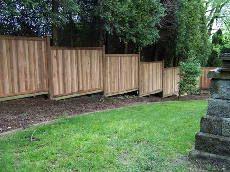 Building a fence on sloped ground is not that difficult, but there are a few things to consider. A pre-built wood fence would be “stair-stepped” down the slope… and quite easily f… Yard Fence Ideas, Wood Fence Design, Sloped Yard, Yard Fence, Sloped Backyard, Fence Styles, Diy Fence, Front Yard Fence, Building A Fence