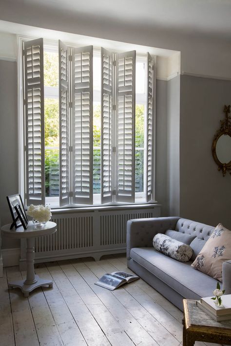 Full height interior wooden shutters in living room | Making the most of your windows | Luxaflex shutters | Apartment Apothecary House Window Shutters, Aesthetic Blinds, Apartment Apothecary, Bungalow Makeover, Bookcase Doors, Classic Shutters, Curtains And Shutters, Hunter Douglas Blinds, Ikea Blinds