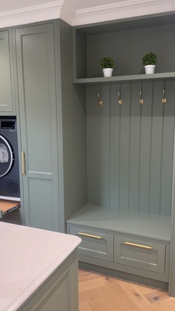 Trevor McDonnell Kitchens on Instagram: "The utility room at the “ Brookhill house project “  . . . We love the boot bench and the raised washer & dryer in this utility room. it made life for our clients so functional  . . A green utility room with raised washing machine and dryer combines practicality with a fresh, vibrant aesthetic. The green color palette, ranging from soft sage to rich emerald, infuses the space with a sense of calm and connection to nature.  The washing machine and dryer are elevated on sturdy platforms, making them easily accessible without the need to bend down, which enhances ergonomic convenience. These platforms often include built-in storage drawers underneath, perfect for housing laundry detergents, fabric softeners, and other cleaning supplies.  Cabinetry in c Raised Washing Machine, Elevated Washer And Dryer, Sage Laundry Room, Raised Washer Dryer, Green Utility Room, Utility Room Inspiration, Boot Bench, Utility Space, Entrance Hall Decor