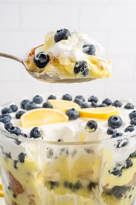 a spoonful of lemon blueberry trifle. Blueberry Trifle Desserts, Lemon Blueberry Trifle Recipes, Lemon Trifle Recipes, Blueberry Trifle Recipe, Lemon Blueberry Trifle, Lemon Trifle, Blueberry Trifle, Trifle Recipes Easy, Blueberry Pudding