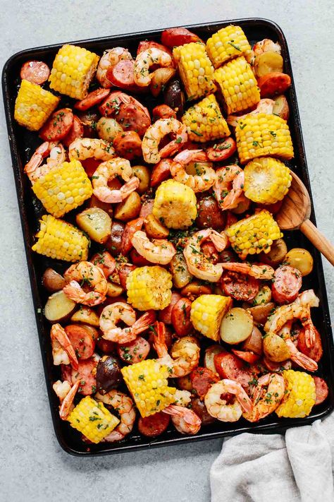 This shrimp boil recipe has all the flavor of the classic dish without the mess. Make this recipe tonight for a delicious meal in just 30 minutes! Oven Shrimp, Shrimp Boil In Oven, Low Country Boil Recipe, Sheet Pan Shrimp Boil, Pan Shrimp Boil, Shrimp In The Oven, Boil Recipes, Shrimp Corn, Shrimp Boil Recipe