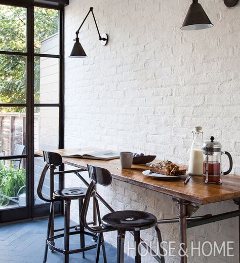 Two designers weigh in on iron doors and windows. | Photographer: Donna Griffith Painted Brick Interior Wall, Painted Brick Interior, White Brick Interior, Brick Veneer Wall, Spec House, Kitchen Design Black, Brick Accent Wall, Painted Brick Walls, Bistro Kitchen