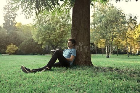 Spare time. Young man sitting under a tree in a park and reading a book , #AD, #Young, #man, #Spare, #time, #sitting #ad Sitting Under A Tree, Under A Tree, Nature Sketch, Tree Pose, Sitting Poses, Man Sitting, Person Sitting, Garden Photography, Man Standing