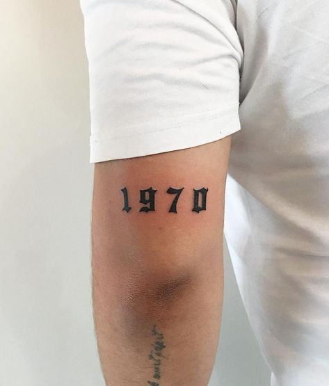 The year 1970 tattoo inked above the left elbow by @soychapa Number Tattoos On Arm, Small Roman Number Tattoo, 777 Tattoo On Arm, Numbers On Back Of Arm Tattoo, 1970 Tattoo, Angel Number Tattoo Back Of Arm, Knuckle Tattoos, Full Body Tattoo, Traditional Tattoo Sleeve