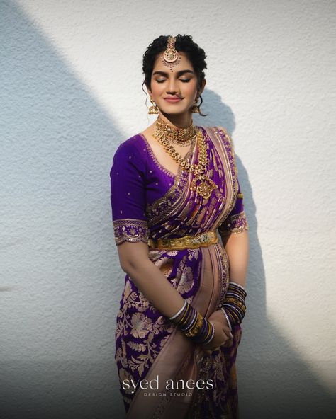 The stunning @maddipatlasanjana dazzles in a regal purple Benarasi saree, adorned with intricate golden zari work that forms beautiful floral patterns. The saree’s rich purple hue, contrasted with the soft elegance of rose dust, creates a timeless blend of tradition and sophistication—an impeccable choice for those who cherish grace and grandeur. 👰Bride - @maddipatlasanjana 📸 Photography - @vijayeesamandco 💄 Makeup Artist - @afsharangila_makeupartist [ Syed Anees Design Studio, Bridal We... Banarasi Saree For Reception, Jewellery For Purple Saree, Blouse Designs For Benarasi Saree, Purple Nauvari Saree Bride, Benaras Dresses Designs, Purple Saree Bride, Purple Saree Makeup Look, Purple Blouse Designs For Saree, Purple Bridal Saree