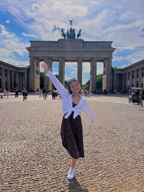 Young Asian American woman stands in front of Berlin’s Brandenburg Gate wearing a white button up shirt and a black floral dress while on a summer trip to Europe. European Summer Dress Outfit, Europe August Outfit, Austria Fashion Summer, Poland Summer Outfit, Summer Outfits In London, Modest Europe Outfits, Summer In Amsterdam Outfit, Netherlands Outfits Summer, Berlin Outfit Summer