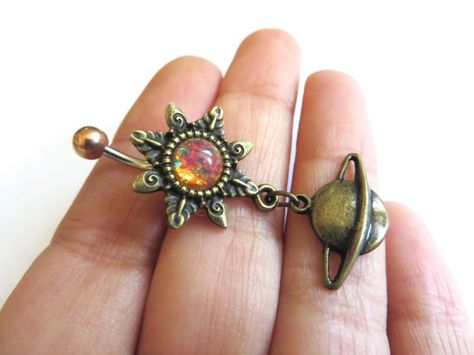 Super unique and gorgeous pink glass opal with a bronze sunburst setting and saturn charm. The bar is 14 gauge surgical steel and measures 11mm. Bellybutton Piercings, Belly Button Piercing Jewelry, Belly Piercing Jewelry, Belly Button Jewelry, Star Burst, Indie Jewelry, Belly Jewelry, Navel Piercing, Belly Piercing