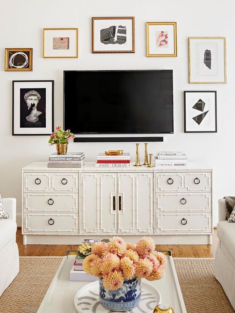 A wall-mounted TV masquerades as part of a gallery wall. Tv Over Dresser In Bedroom Mounted, Credenza Decor With Tv, Dresser Styling With Tv Above, Mounted Tv Above Dresser, How To Style Around A Mounted Tv, Dresser Decor Tv Above, Tv Mounted Above Dresser, Bedroom Gallery Wall Above Dresser, Tv Wall Design Vintage