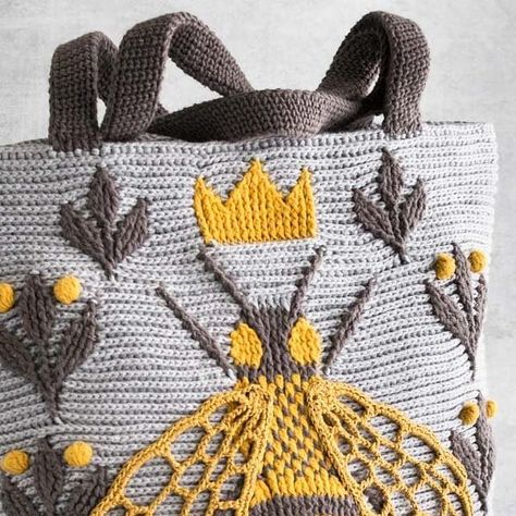 Natalia Kononova on Instagram: "It took me a while to turn Queen Bee Bag crochet pattern idea into an actual bag. Then maybe just a bit less to make the prototype because I wanted that bee yo be as pretty as possible and she was demanding :)) This is embossed crochet, a combination of front post and back post stitches. Pattern is at OutstandingCrochet.com via link in bio, BAGS. Yarn: fingering /4ply weight such as Scheepjes Cotton 8 or Hobbii Rainbow Cotton 8/4 #outstandingcrochet #crochetpattern #crochetbagpattern #embossedcrochet #crochetbee #crochet #crochetaddict #scheepjes #hobbii" Crochet Bee, Crochet Bag Pattern, Queen Bees, Crochet Bag, Color Combos, Royal Blue, Beautiful Colors, Bee, Queen