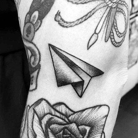 Simple Black And Gray Tattoo Design, Traditional Paper Airplane Tattoo, Small Traditional Tattoo Fillers Black, Gap Filler Tattoo Ideas Black And Grey, Skull Filler Tattoo, Black Filler Tattoo, Gap Filler Tattoo Black And Grey, Tattoo Filler Ideas Men, Background Filler Tattoo