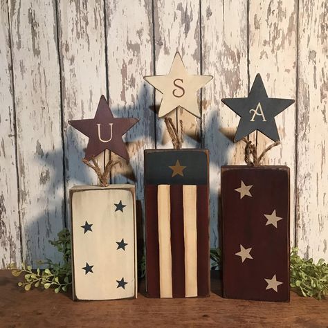 I have designed this set of primitive wood firecrackers to make a nice shelf sitter grouping for your primitive Americana patriotic home decor. I have painted them in burgundy, ivory and adriatic blue with accents of a vertical flag and assorted stars. At the top I have added jute with painted stars with the letters USA. These will look nice on mantels, shelves, buffets, tables and counters. Back will be stained. Tallest one will be 13 high and all will be 3.5 wide. Wood Ruffles and Lace Primitive Americana Crafts, Fourth Of July Wood Crafts, Wood Fireworks Craft, 4th Of July Wood Decor, Wood Block Firecrackers, Red White And Blue Wood Crafts, 4x4 Wood Crafts, Primitive Americana Decor, Fouth Of July Crafts