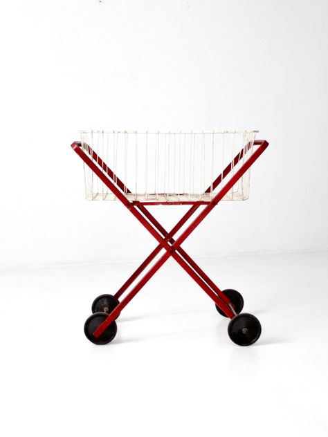 This is a mid-century laundry cart.  The rolling red metal cart features black wheels and a removable white metal basket.   CONDITION In good condition with wear consistent with age and use.  General usage wear with scratches and some light corrosion.  MEASUREMENTS Height:  31.5"  ..  80 cm Length: 28.5"  ..  72.4 cm Width:  17.5"  ..  44.5 cm 918109 Rolling Laundry Cart, Wooden Desk Chairs, Metal Cart, Laundry Cart, Glass Mixing Bowls, Lawn Furniture, Welcome To My House, Metal Basket, Kitchen Bowls