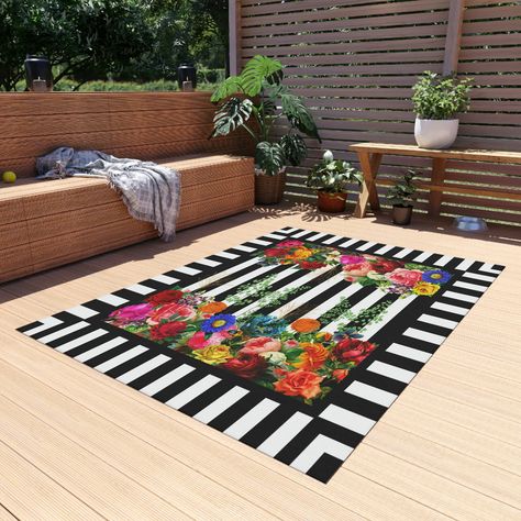 Elevate your outdoor living area with the stunning and romantic design of this Striped Rug. Featuring multicolored vintage flower graphics on a black and white stripes background with green leaf sprigs, this rug adds a touch of nature to your space. The gold foil outlined leaves add a touch of elegance and sophistication to the rug. Floor Decoration. Rugs. Floor Decor. Available on Etsy Black And White Striped Area Rug, Black And White Stripes Background, Pool Oasis, Rug Black And White, Black And White Cushions, Black And White Rug, Flower Graphics, Stripes Background, Floor Decoration