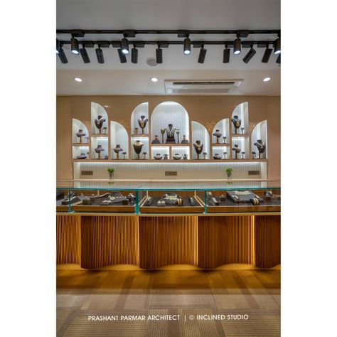 For providing the Spacious Feeling to the Space, the backdrop is designed with the combinations of arched mirrors. The curved arches for showcasing the jewellery and soft, irregular shape of the curved fluted panels below the counter adds luxurious look to the showroom.
.
“A Jewellery Boutique Design”
Location: C G Road, Ahmedabad, Gujarat, India.
Carpet Area: 1,500 Sq. Ft.

PC:  Inclined Studio Jewellery Display Counter Design, Jewelry Interior Design Shop, Counter Design Shop Retail Stores, Showroom Counter Design, Jewellery Counter Design, Jewellery Shop Counter, Jewellery Showroom Interior Design, Jewelry Store Interior Design, Prashant Parmar