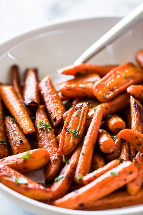 Oven roasted carrots tossed with melted butter, maple syrup, garlic and a touch of cinnamon. A great side dish worthy of being served at your holiday table! Can be made with whole or baby carrots in 30 minutes or less. Paleo, vegetarian and gluten free. #thanksgiving #easter #easysidedish #carrots Thanksgiving Carrot Recipe, Thanksgiving Carrots, Carrots In Oven, Gluten Free Mexican Recipes, Cinnamon Carrots, Carrots Roasted, Oven Roasted Carrots, Roasted Baby Carrots, Isabel Eats