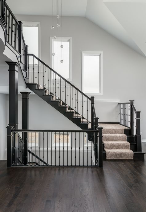 Beautiful stairs with iron balusters, drop lighting and plenty of windows! Wellsley II floor plan by King's Court Builders, Naperville, IL.(11AE) Staircase Design With Window, Stairs Window Design From Outside, Stairs Window Design, Stairs With Windows, Stair Window Ideas, Cabin Stairway, Window Railing Design, Railings For Stairs, Modern Foyer Design