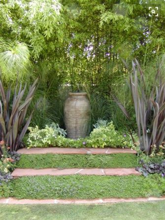 A simple urn may be used as a focal point in a soothing garden corner. Urn Garden Ideas, Focal Point Plants Garden Design, Garden Feature Ideas Focal Points, Focal Points In Gardens, Landscape Focal Point Ideas, Garden Focal Point Ideas Inspiration, Garden Features Focal Points, Backyard Focal Point, Garden Focal Point Ideas