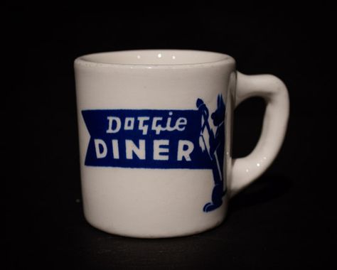 Doggie Diner  Mug  by Tepco China, circa 1950s Offered by Track 16. http://www.track16.com #restaurantware #restaurantchina 50s Prime Time Cafe, Diner Mug Design, Cafe 50s, 1980s Restaurant, Restaurant Dinnerware, Luke’s Diner Coffee Mug, Diner Coffee, Diner Mug, Diner Mugs Vintage