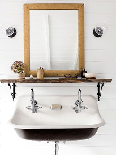 Anthropologie's iron brackets turn a slab of repurposed wood into a shelf in this master bath. The sink is Kohler. Kohler Brockway Sink, Sink Shelf, Trough Sink, Cottage Bathroom, Bad Inspiration, Boys Bathroom, Bathroom Renos, Farmhouse Bathroom, Bathroom Shelves