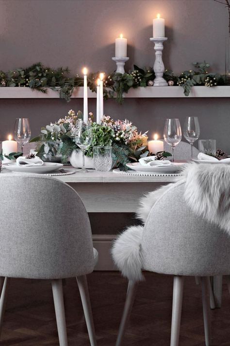 Go for a natural palette this Christmas with an all-grey scheme. Add texture with soft fabric dining chairs, faux fur throws and pom-pom lined placemats. Finish off the friendly setting with candles. Click for more Christmas table decorating ideas #homedecor Image: Next Grey And Gold Christmas Table, Grey Christmas Table Decor, Christmas Table Ideas Silver, Faux Fur Dining Chair Throw, White Table Cloth Christmas Setting, Dinner Setting Ideas, Silver And Gold Christmas Table Decor Place Settings, Pink Scheme, Fur Dining Chair