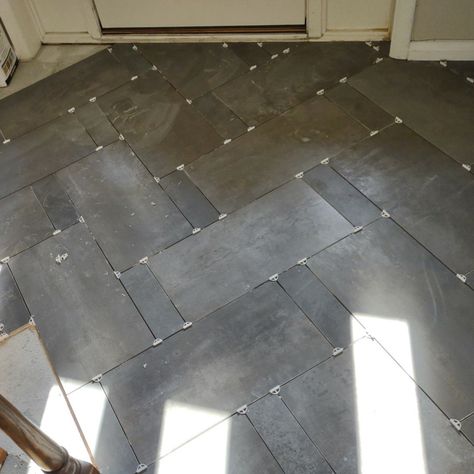 This foyer deserved an update, the floor especially ! Check out our design featuring a twist on the classic herringbone tile pattern! 🌟 We took a popular pattern made of large tiles (12 x 24) and added smaller tiles (4 x 12) to create a unique and elegant statement. Who knew a simple tweak could make such a difference? 🤩 With a little creativity and attention to detail, you can transform any floor in your home without breaking the bank. This design proves that sometimes it's the small change... Chevron Stone Floor, 12x24 Herringbone Floor Tile, 12 X 24 Tile Patterns, Herringbone Tile Bathroom Floor, 12x24 Tile Patterns, Entryway Tile Floor, Unique Tile Floor, Herringbone Tile Floor, Foyer Tile