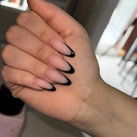 Black Almond Nails with a French Tip Twist 🖤🤍 A modern take on a classic. These black almond nails with a white French tip are chic and timeless. #frenchtipnails #blacknails #almondnails #nails #nailart #manicure #pedicure #nailinspiration #naildesigns #beauty #fashion #style Black French Nails Almond, Oval Black Nails, Black French Manicure Almond, Almond Nails Black French Tip, Black Almond French Nails, Matte Black French Tip Nails, Black French Almond Nails, French Tip Almond Nails With Design, Almond Black French Tip Nails