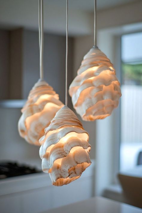 Incorporate coastal elements into your lighting with seashell pendant lights. These unique fixtures add a beachy, whimsical touch to any room, casting soft, diffused light. Seashell Pendants, Diffused Light, Sea Shells, Pendant Lighting, It Cast, Lighting, Pendant